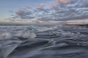 Waves of the atlantic ocean break over icebergs outside the glacial lagoon jokulsarlon; iceland Waves of the atlantic ocean break over icebergs outside the glacial lagoon jokulsarlon; iceland