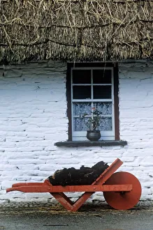 Wheelbarrow In Front Of A Window Of A Cottage, Bunratty Folk Park, Bunratty, County Clare, Republic Of Ireland Wheelbarrow In Front Of A Window Of A Cottage, Bunratty Folk Park, Bunratty, County Clare, Republic Of Ireland