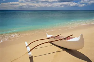 White Outrigger Canoe On Shoreline With Shadow, Calm Turquoise Water White Outrigger Canoe On Shoreline With Shadow, Calm Turquoise Water