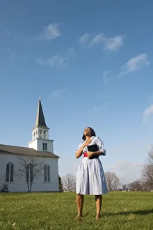 Woman Outside With Bible, Standing Near A Church, Praying Woman Outside With Bible, Standing Near A Church, Praying