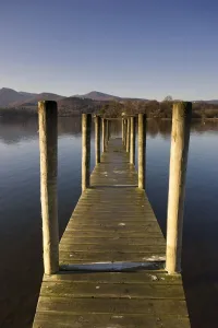 A Wooden Dock Going Into The Lake, Cumbria, England A Wooden Dock Going Into The Lake, Cumbria, England