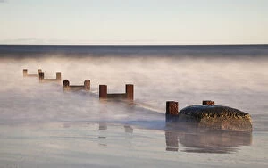 Images Dated 22nd January 2012: Wooden Posts And Boulders Immersed In Water At The Coast; Northumberland, England