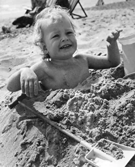 3 year old Bradley Hook up to his arm-pits in the sand at Bournemouth. April 1971 P023604 3 year old Bradley Hook up to his arm-pits in the sand at Bournemouth. April 1971 P023604