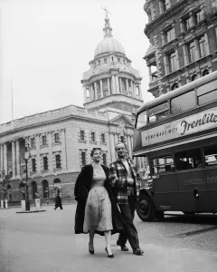 Actor David Niven with French actress Genevieve Page walking through London during a Actor David Niven with French actress Genevieve Page walking through London during a