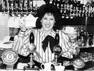 Actress Anita Dobson from Eastenders TV programme on set having cup of tea behind bar of Actress Anita Dobson from Eastenders TV programme on set having cup of tea behind bar of