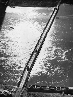 Aerial view of the 1st US Army Trucks and equipment rolling across a pontoon bridge over Aerial view of the 1st US Army Trucks and equipment rolling across a pontoon bridge over