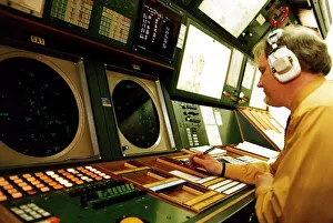 Air Traffic control man wearing earphones headphones at instruments desk airport control Air Traffic control man wearing earphones headphones at instruments desk airport control