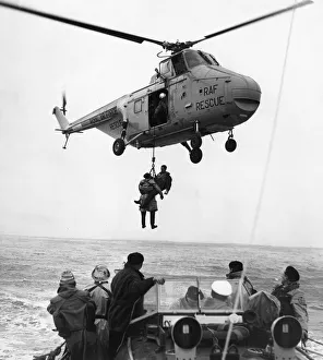 Two airmen are hoisted to the safety of an RAF helicopter after being picked up by Barry Two airmen are hoisted to the safety of an RAF helicopter after being picked up by Barry