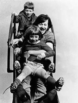 Alex Higgins former World Snooker Champion 1983 with two children holding on to Alex Higgins former World Snooker Champion 1983 with two children holding on to