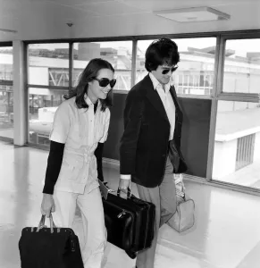 American actor Warren Beatty at Heathrow Airport with Michelle Phillips. May 1975 American actor Warren Beatty at Heathrow Airport with Michelle Phillips. May 1975