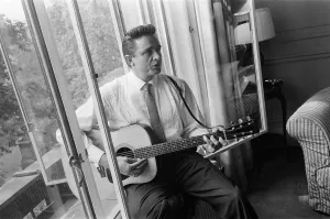 American country singer and musician Johnny Cash poses for photographers at the Savoy American country singer and musician Johnny Cash poses for photographers at the Savoy