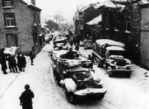 American troops pass through snow-covered street in Lierheux Belgium during WW2 American troops pass through snow-covered street in Lierheux Belgium during WW2