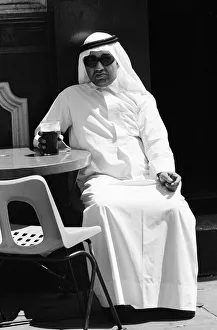 Arab man sitting outside enjoying a pint of Guinness at the Stanhope public house Arab man sitting outside enjoying a pint of Guinness at the Stanhope public house