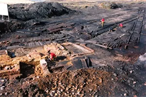 Archaeologists digging up a perfectly preserved wooden railway which had lain buried Archaeologists digging up a perfectly preserved wooden railway which had lain buried