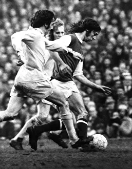 Arsenal footballer Charlie George fights off 2 Bradford defenders as he makes an attack Arsenal footballer Charlie George fights off 2 Bradford defenders as he makes an attack