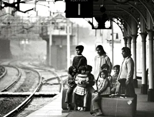 Asian immigrant family waiting at Bishops Stortford train station to travel to London Asian immigrant family waiting at Bishops Stortford train station to travel to London