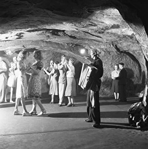 Accordions Collection: The audience of a performance of the Pirates of Penzance in the caves in the cliffs above