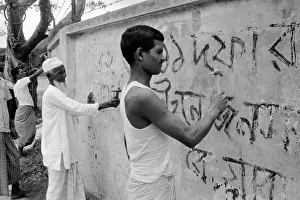 Bangladesh - signs being chipped off walls, by order of the Military Government Bangladesh - signs being chipped off walls, by order of the Military Government