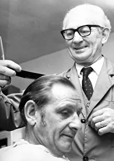A barber cutting a mans hair in April 1972 A barber cutting a mans hair in April 1972