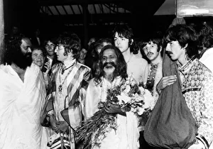 The Beatles with the Maharishi Mahesh Yogi who is clutching bundles of flowers Beatles The Beatles with the Maharishi Mahesh Yogi who is clutching bundles of flowers Beatles