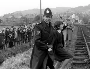 The Beatles March 1964 A policeman escorts away school children try to meet The Beatles March 1964 A policeman escorts away school children try to meet