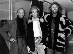 The Bee Gees Pop Group leaving Heathrow for Paris. Robin Gibb flanked by his two The Bee Gees Pop Group leaving Heathrow for Paris. Robin Gibb flanked by his two
