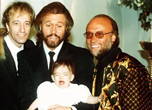 Bee Gees pop group Maurice Gibb Robin Gibb and Barry Gibb with his baby daughter Bee Gees pop group Maurice Gibb Robin Gibb and Barry Gibb with his baby daughter