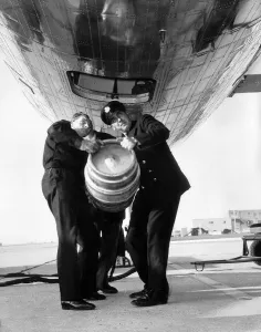 A beer barrel is loaded into the cargo hold of a De Havilland Comet at London Airport A beer barrel is loaded into the cargo hold of a De Havilland Comet at London Airport