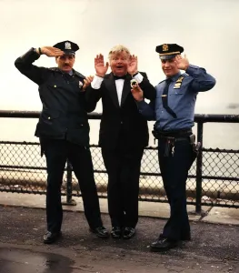 Benny Hill actor and comedian is hancuffed in a send up of the TV Programme " Benny Hill actor and comedian is hancuffed in a send up of the TV Programme "