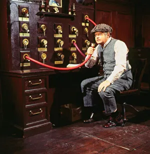 Benny Hill comedian November 1985 Sitting speaking into hose machine wearing cap Benny Hill comedian November 1985 Sitting speaking into hose machine wearing cap