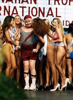 Benny Hill Comedian stands between bikini clad contestrants at a beauty competition Benny Hill Comedian stands between bikini clad contestrants at a beauty competition
