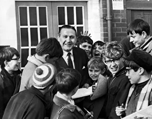 Former Blackpool footballer and current manager Stanley Mortensen surrounded by young Former Blackpool footballer and current manager Stanley Mortensen surrounded by young