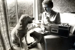 Blind Cardiff City Councillor Joan Ward, recording her notes while her guide dog Jenny Blind Cardiff City Councillor Joan Ward, recording her notes while her guide dog Jenny
