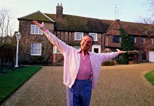 Bob Monkhouse outside house arms spread April 1989 Bob Monkhouse outside house arms spread April 1989
