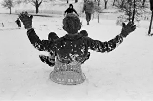 A boy sledging on a clothes basket in Greenwich Park, London, 27th December 1970 A boy sledging on a clothes basket in Greenwich Park, London, 27th December 1970