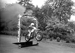 Images Dated 8th June 1980: Boy Stunt Rider: 6 year old Darius Goodwin is pictured here leaping through flames for