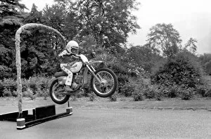 Images Dated 8th June 1980: Boy Stunt Rider: 6 year old Darius Goodwin is pictured here leaping through flames for