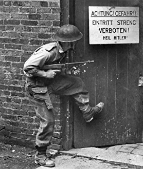 British Army Soldier uses a tommy gun while training to storm a mockup german building British Army Soldier uses a tommy gun while training to storm a mockup german building
