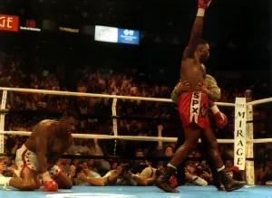 British Heavyweight champion iLennox Lewis raises his arm in celebration after knocking British Heavyweight champion iLennox Lewis raises his arm in celebration after knocking