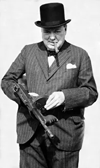 British Prime Minister Winston Churchill holding a Thompson submachine gun whilst smoking British Prime Minister Winston Churchill holding a Thompson submachine gun whilst smoking