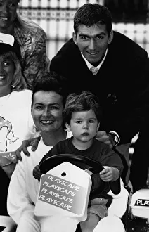 British racing driver Damon Hill and his wife Georgie try out their son Joshua behind British racing driver Damon Hill and his wife Georgie try out their son Joshua behind