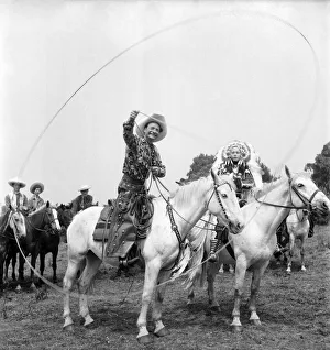 Cal McAndrew on horseback with a lasso seen alongisde - Carol Gray dressed as a Indian Cal McAndrew on horseback with a lasso seen alongisde - Carol Gray dressed as a Indian