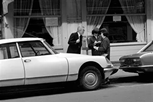 A car driver protesting to traffic wardens after they put a ticket on his car in Paris A car driver protesting to traffic wardens after they put a ticket on his car in Paris
