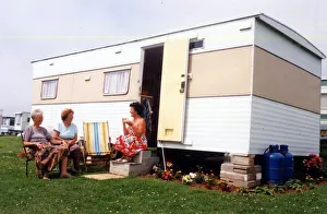 Caravans - Holidaymakers enjoying the sunshine, outside their caravan Caravans - Holidaymakers enjoying the sunshine, outside their caravan