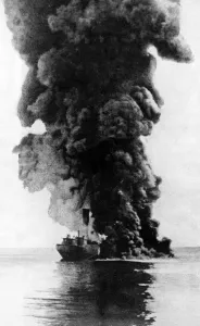 A cargo steamer hit by a u-boat torpedo seen here burning and sinking by the bow A cargo steamer hit by a u-boat torpedo seen here burning and sinking by the bow