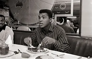 Cassius Clay eating Steaks at Isows restuarant in Brewer Street, Soho, London Cassius Clay eating Steaks at Isows restuarant in Brewer Street, Soho, London