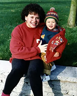 Cheryl Maker Actress who appears in TV soap Brookside sitting on wall with her son Cheryl Maker Actress who appears in TV soap Brookside sitting on wall with her son