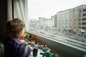 Child looks through window with view of Red light district in Hamburg, West Germany Child looks through window with view of Red light district in Hamburg, West Germany