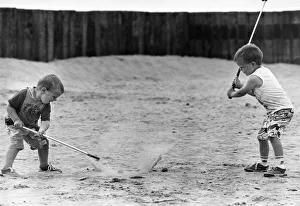 Children practise their golf swing on Ainsdale Beach, Southport Children practise their golf swing on Ainsdale Beach, Southport