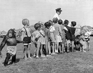 Children queue with their Chimpanzee friend for an ice cream at Billy Smart Circus 6th Children queue with their Chimpanzee friend for an ice cream at Billy Smart Circus 6th